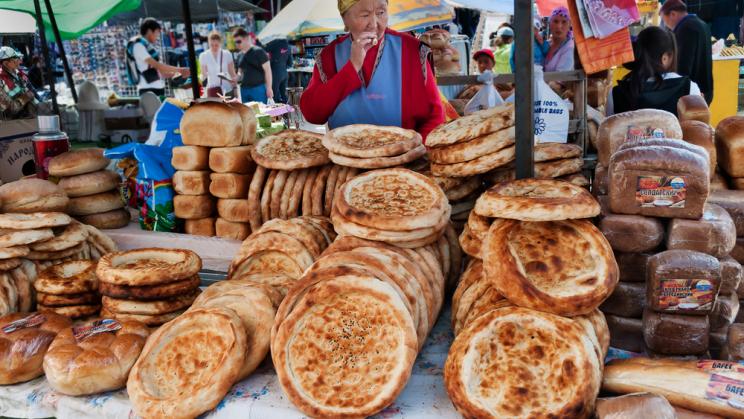 Woman selling bread in a market in Bosteri, Kyrgyzstan