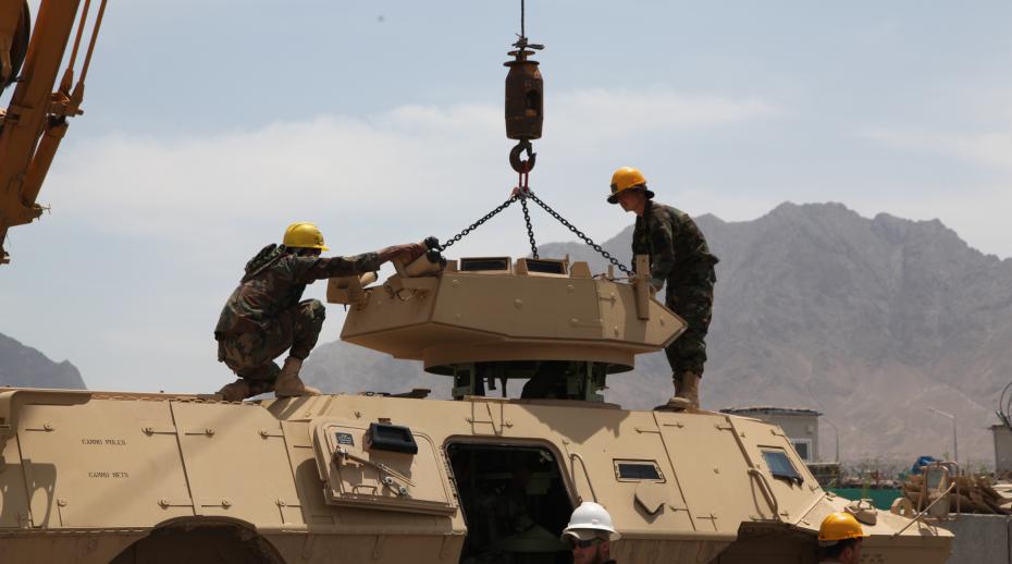 Afghan National Army (ANA) students remove the turret on a mobile strike force vehicle for maintenance
